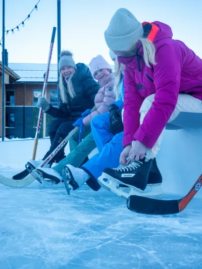 Jenter og damer som tar på seg skøyter.