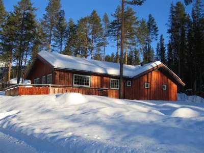Bilde av en rød hytte i skogen i Hemsedal