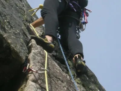 Mann som klatrer i fjellvegg.