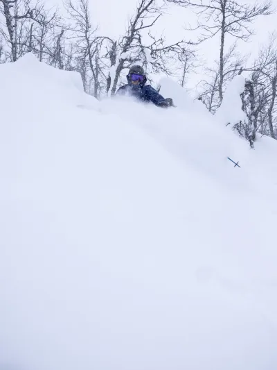 Skiier in deep snow in Hemsedal